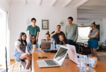 Quem somos? Group of People Watching on Laptop